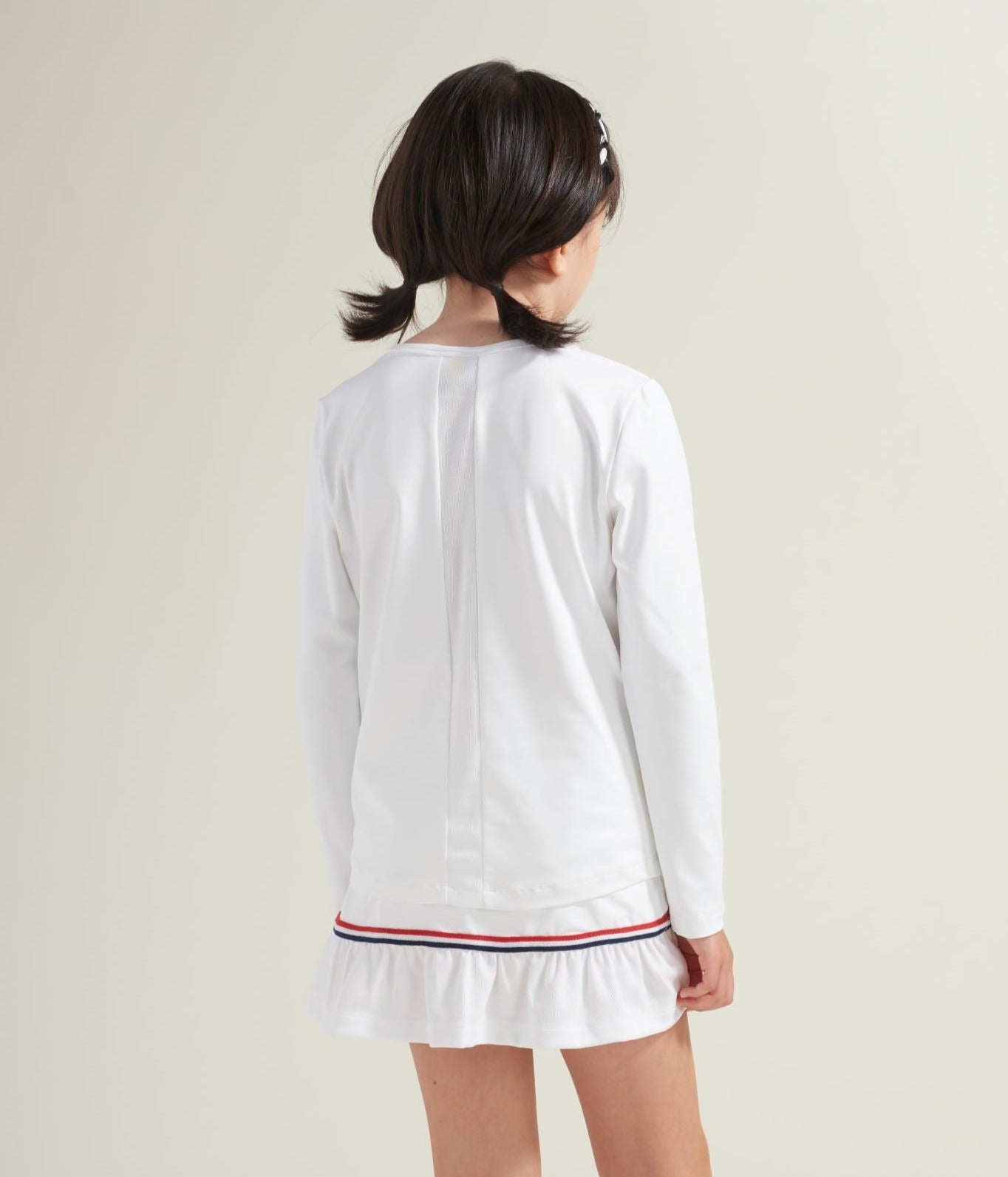 Back view of kids long sleeve tennis shirt with white mesh stripe