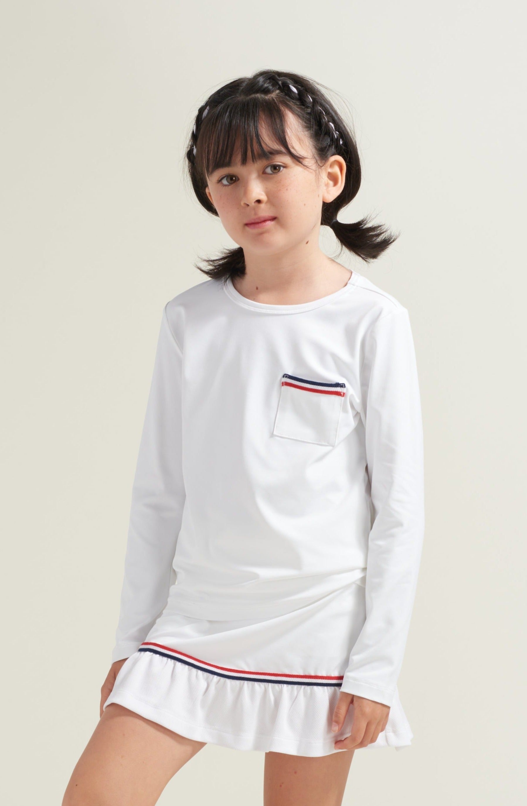 Bright white tennis long sleeve shirt with matching tennis skort for kids youth.