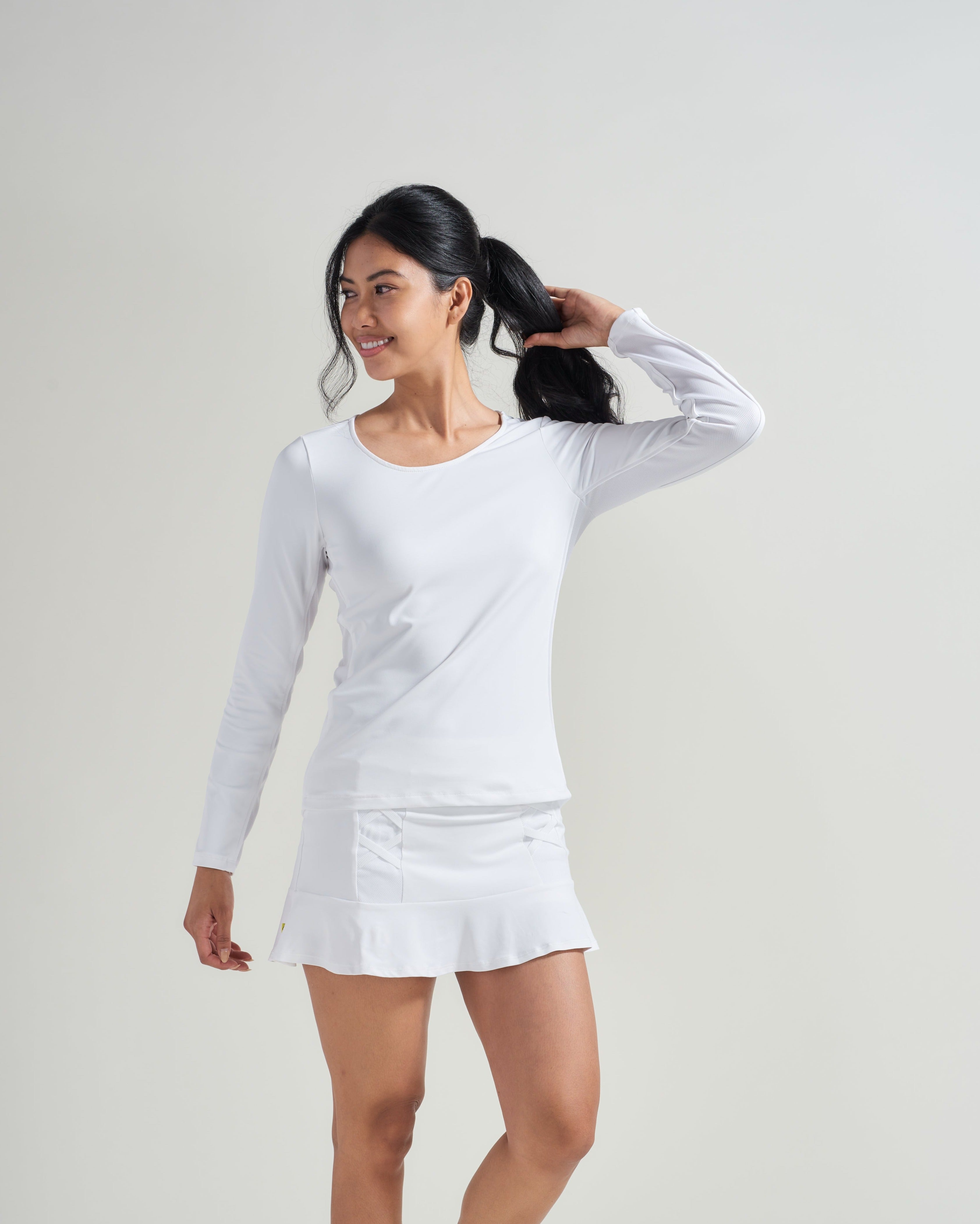 Women's tennis athlete wearing white tennis workout uniform in all white.