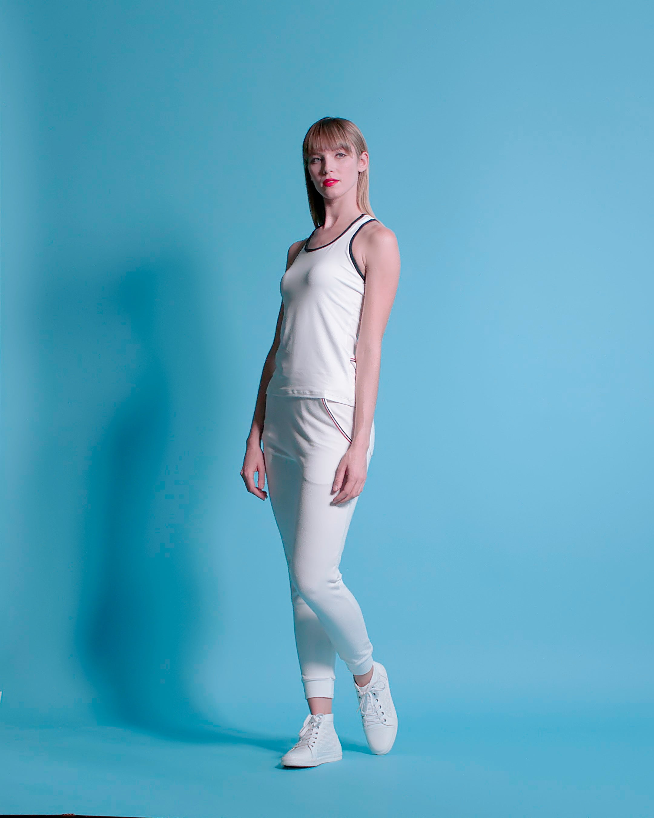 Women's workout outfit in all white with accent trim.