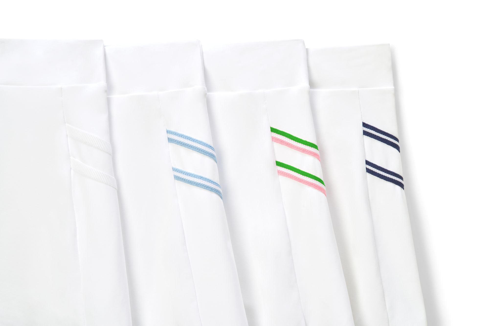 Variety of tennis skort in white with colored trim accents and all white tennis skort option for women.