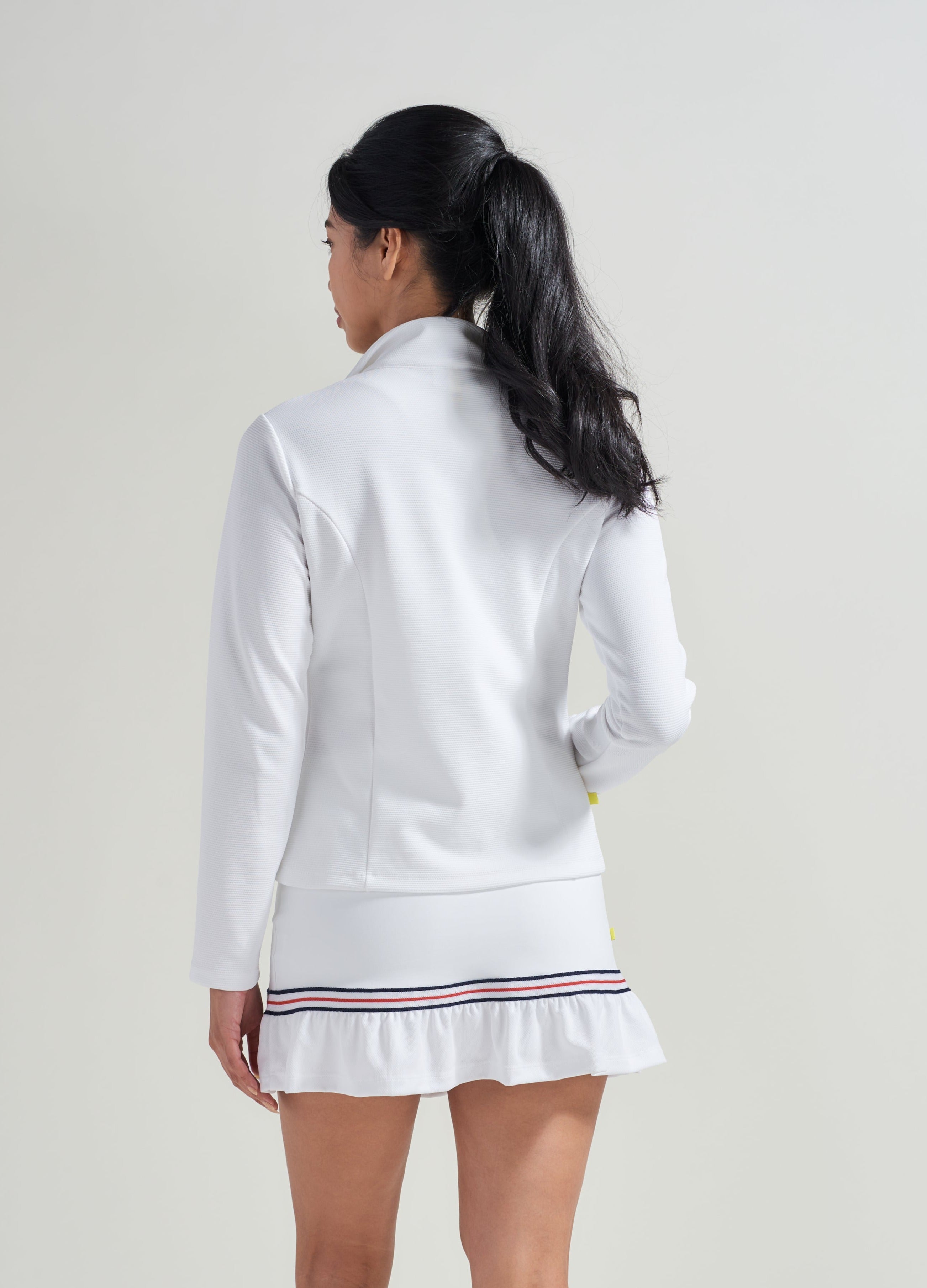 Back view of white tennis jacket with matching tennis skort