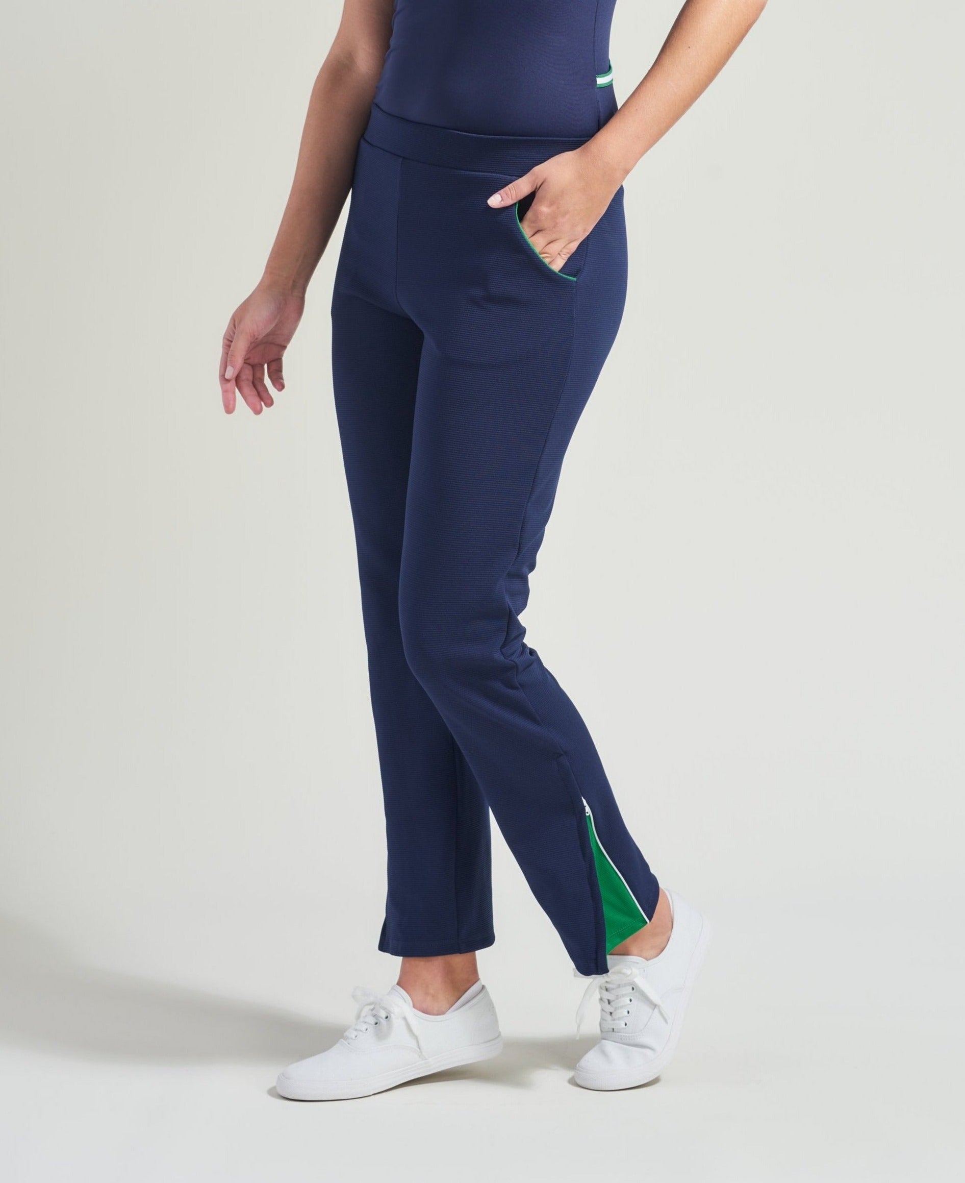 Women's tennis workout pants in navy with green trim.