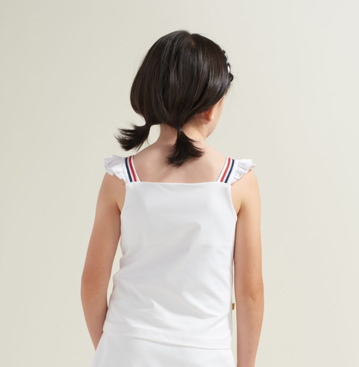 Back view of white tennis shirt with ruffle straps for girls tennis player