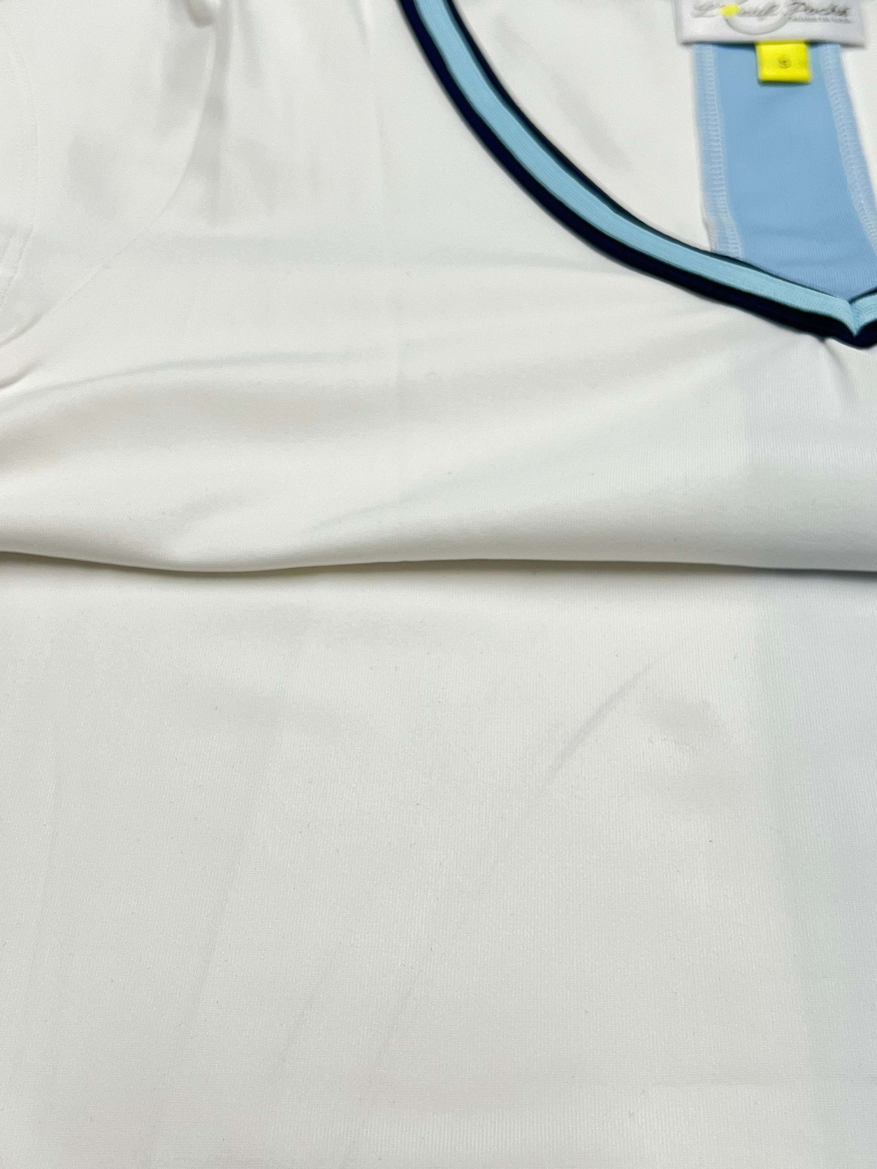 Workout shirt for women in white with navy and blue trim.