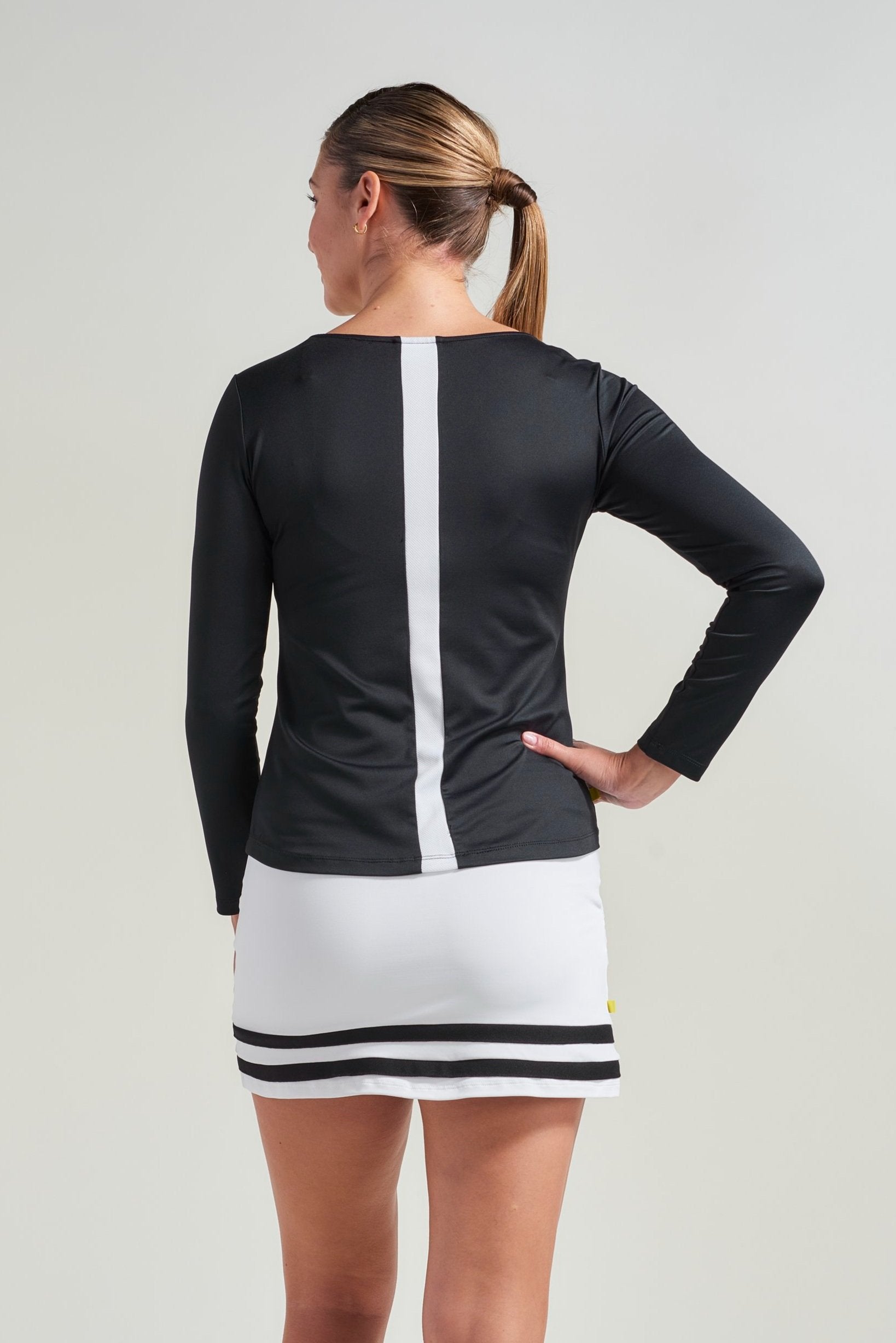 Black view of tennis shirt with white mesh along back.