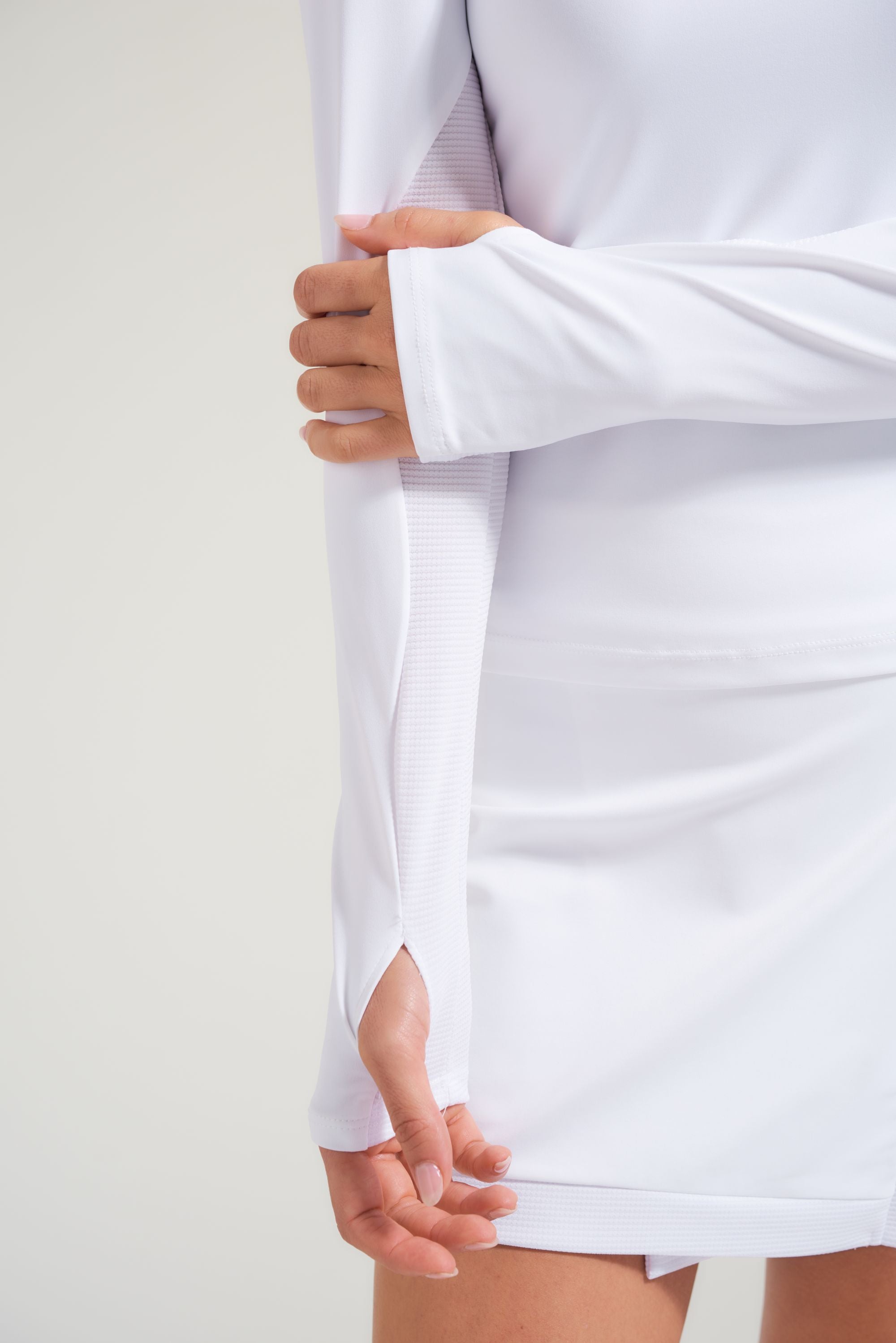 Detail view of tennis long sleeve with thumb hole opening for women's tennis t-shirt.