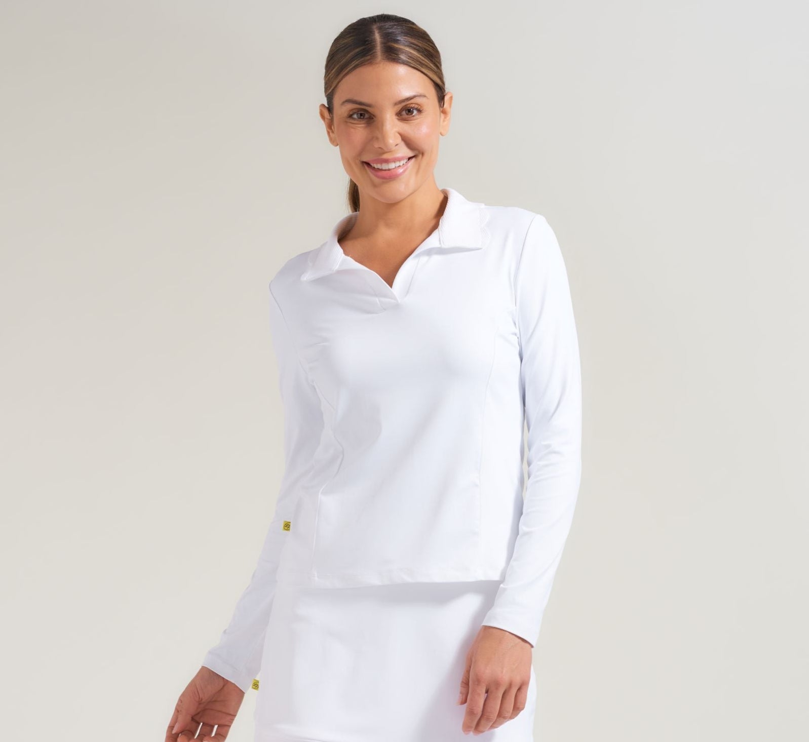 Women's tennis long sleeve polo in white for women.