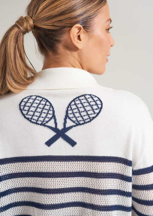 Detail picture of back view of woman in tennis cable knit sweater with tennis racquets and stripe design.