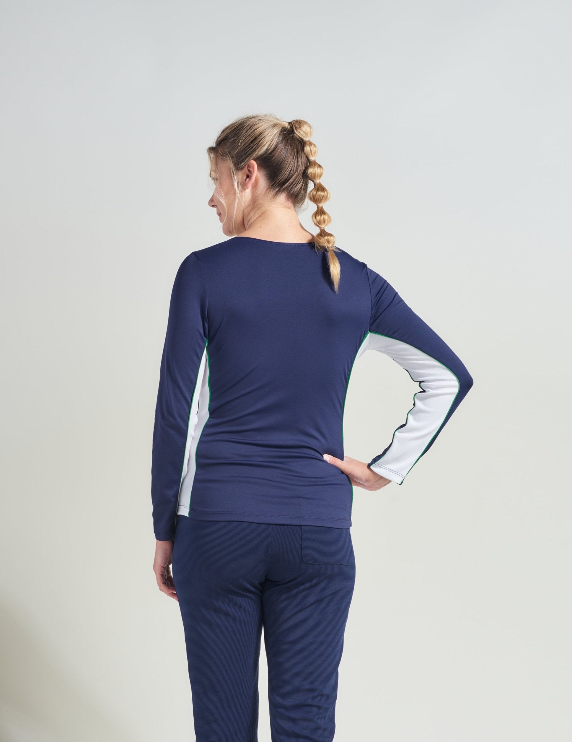 Back view of tennis long sleeve warm up shirt with white mesh along sides and arms for women.