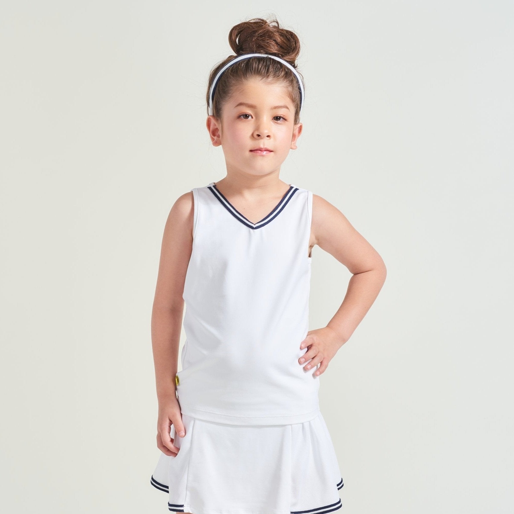 White tennis tank top with navy and white trim along neckline for kids.