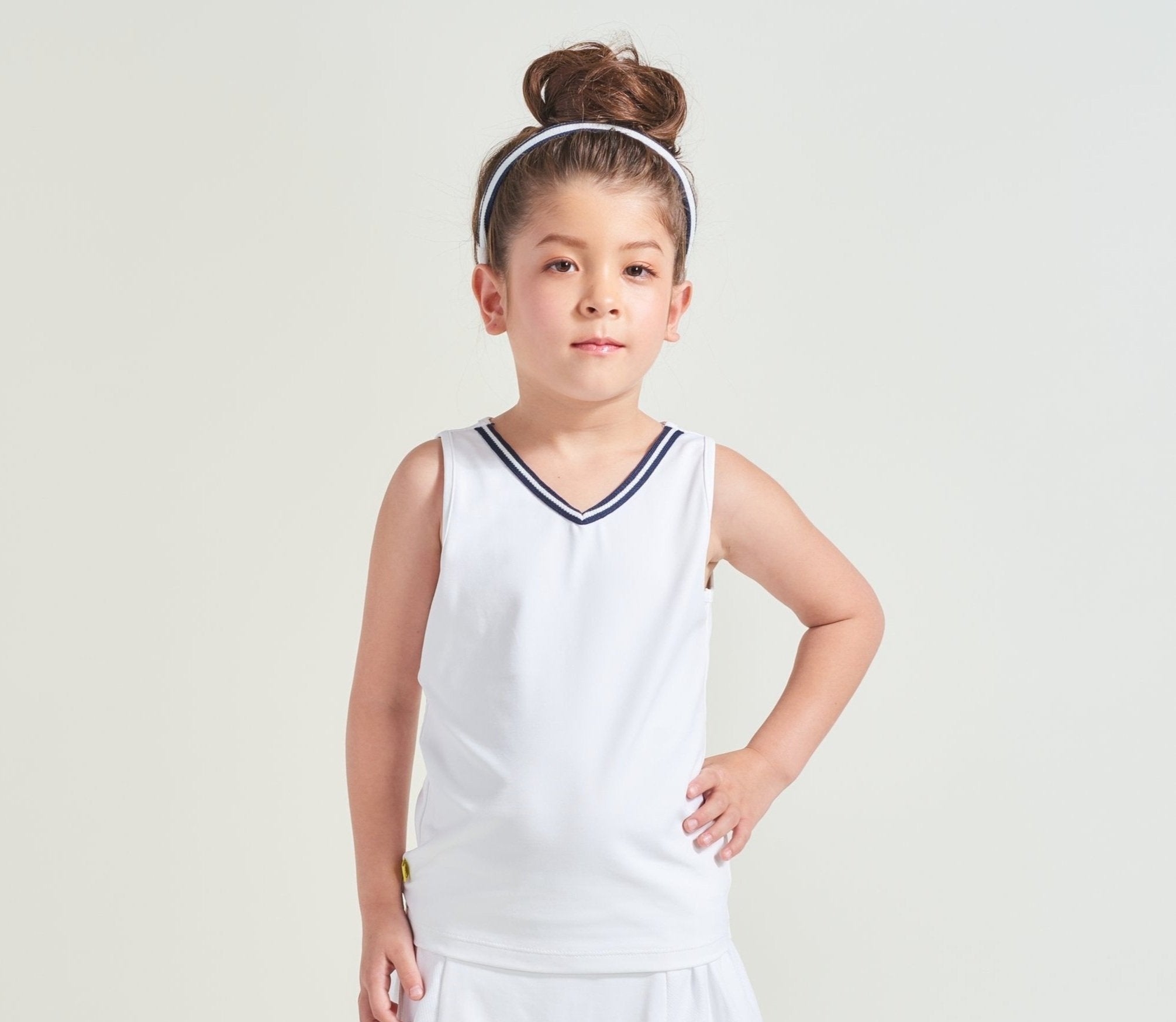 White tennis tank top with navy and white trim along neckline for kids.
