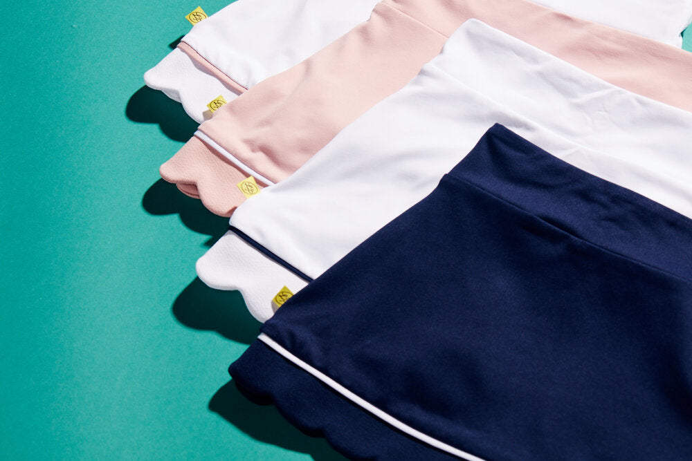 Variety of kids' tennis apparel in different colorways.