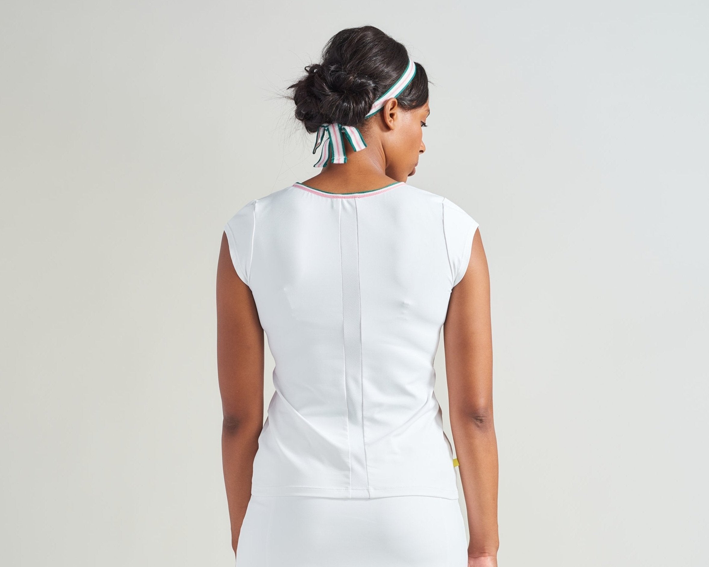 Back view of white tennis skort with mesh insert along back.
