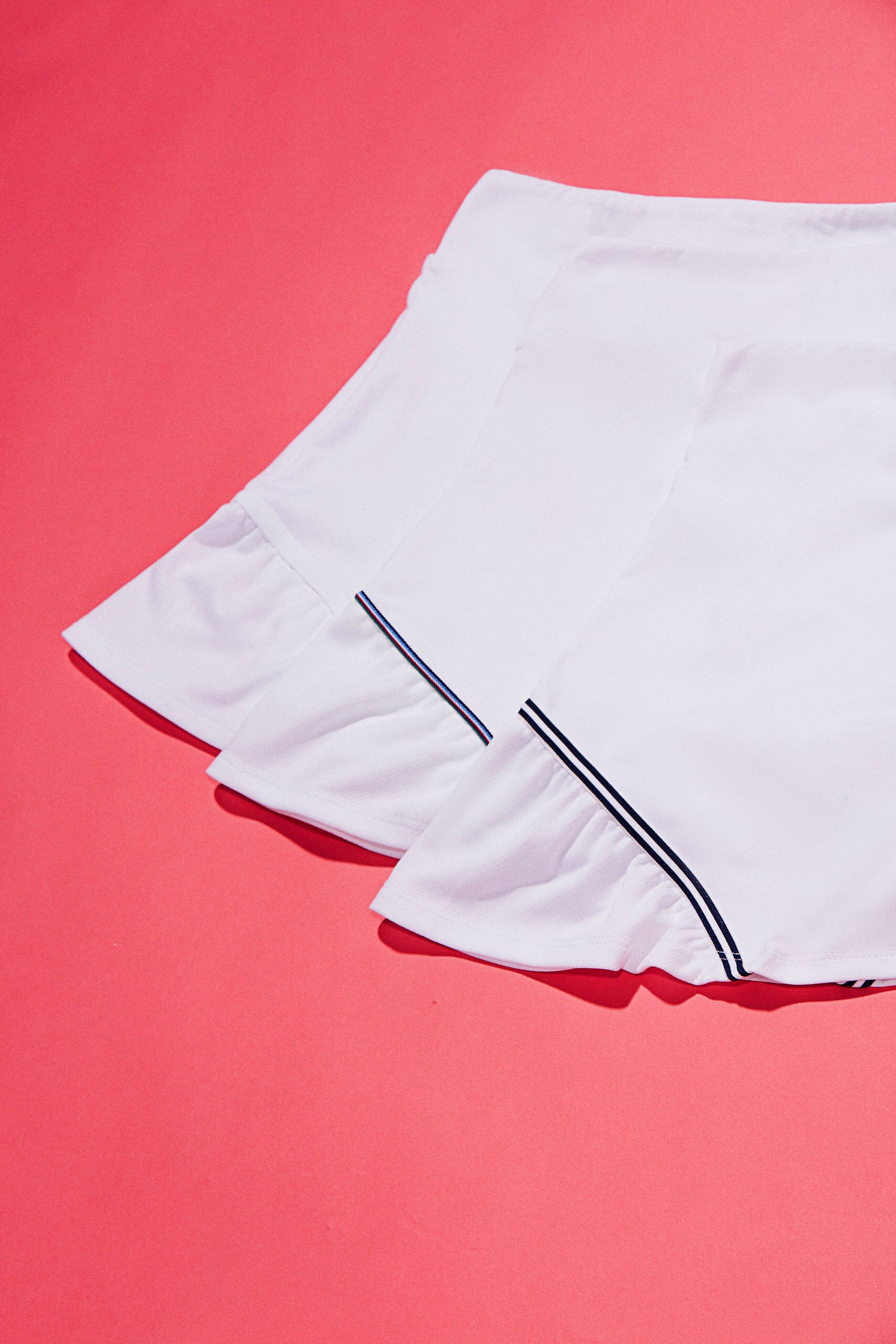 Variety of tennis skort with shirred edges and dark colored trims.