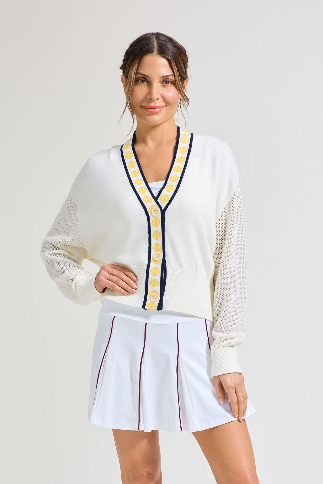 White tennis cardigan and matching white pleated tennis skort for women. 